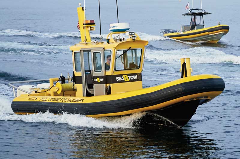 Two Sea Tow boats riding next to another